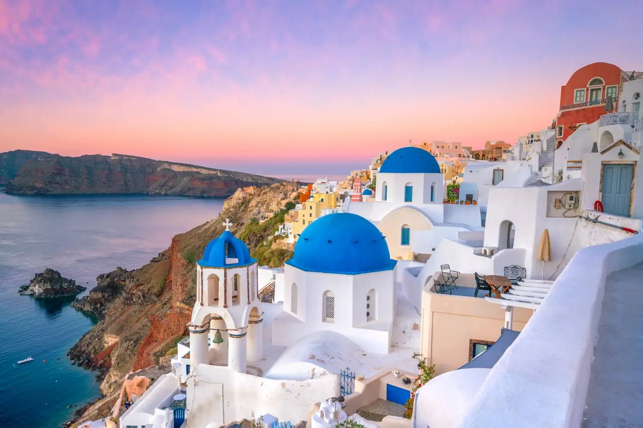 Santorini white buildings blue domes sunset